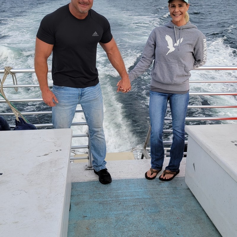 a man standing next to a skateboard