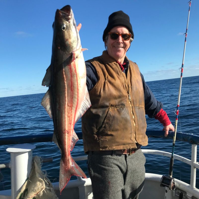 a person holding a fish in the water