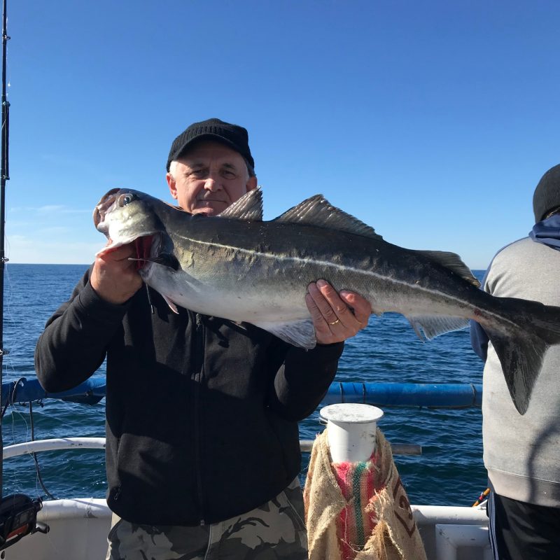a man holding a fish in the water