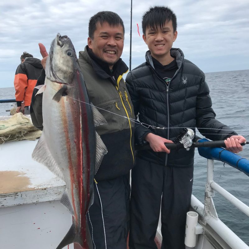 Hiroyoshi Tenzan holding a fish in the water