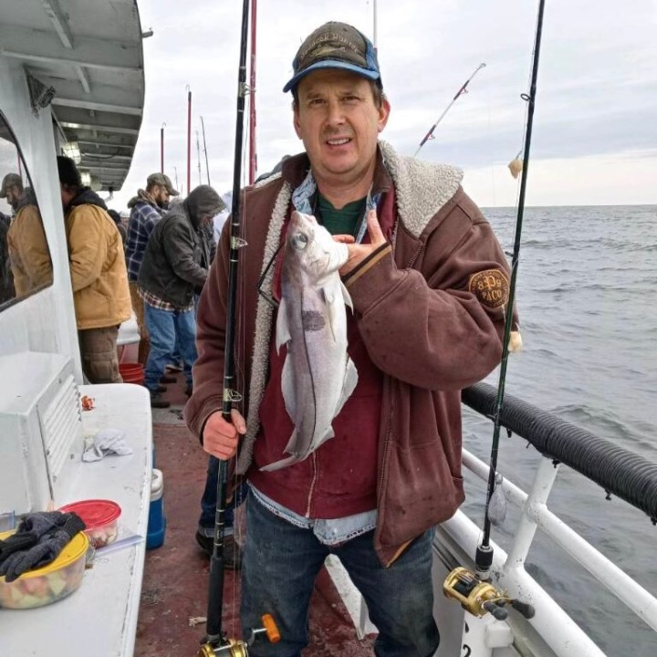 a man and a woman standing next to a boat