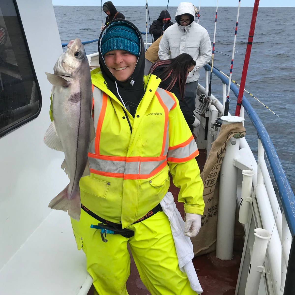 a person standing next to a boat