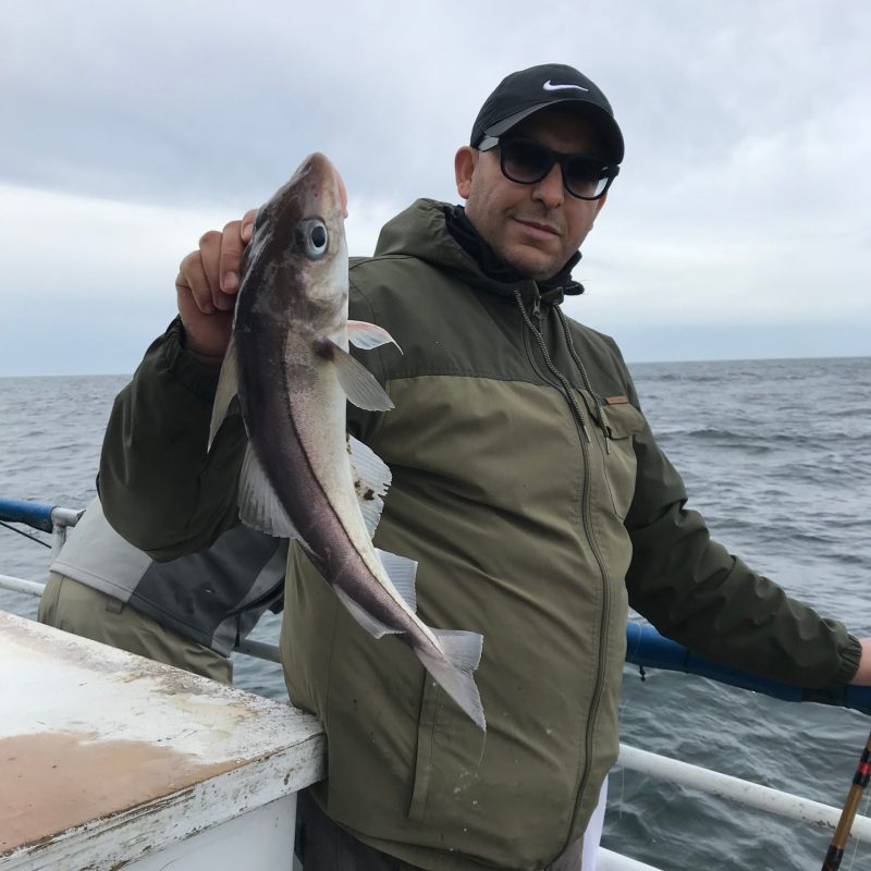 a person holding a fish in the water