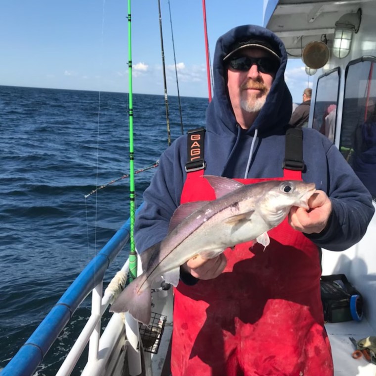 a person holding a fish in the water