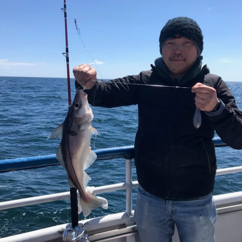 a person holding a fish in the water