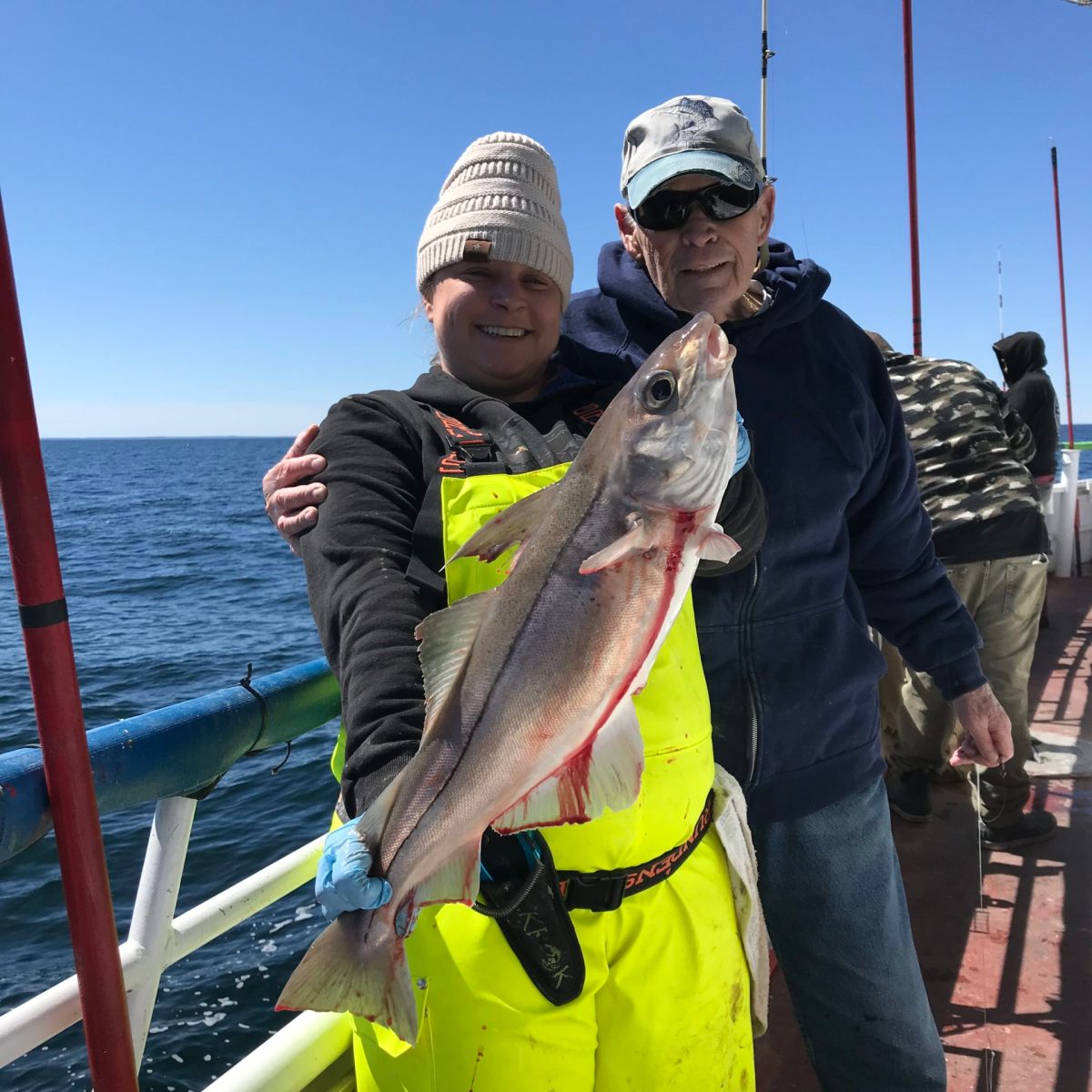 a person holding a fish in the water
