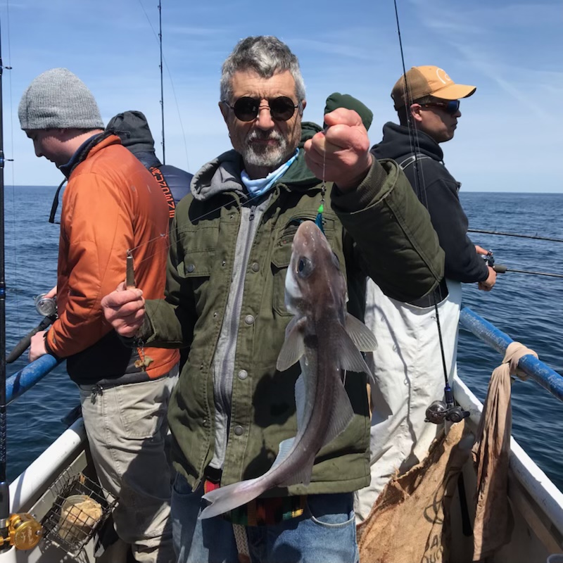 a man holding a fish in the water