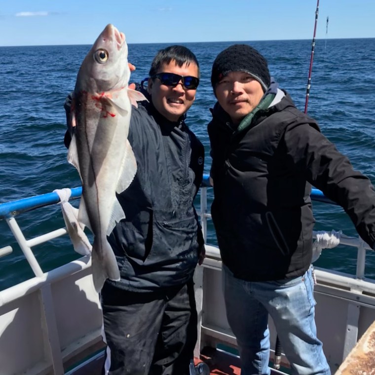 a man holding a fish in the water