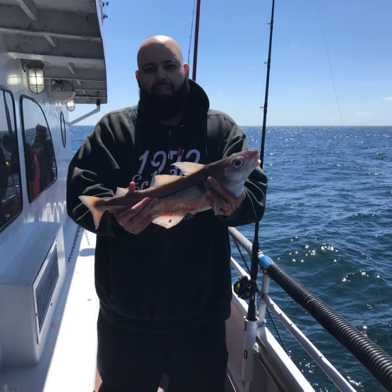a man standing on a boat in the water