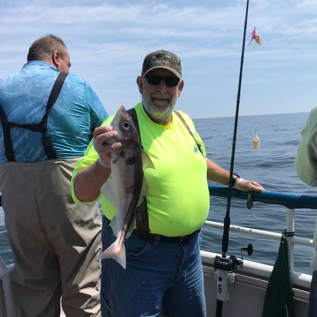 a person holding a fish on a boat in the water