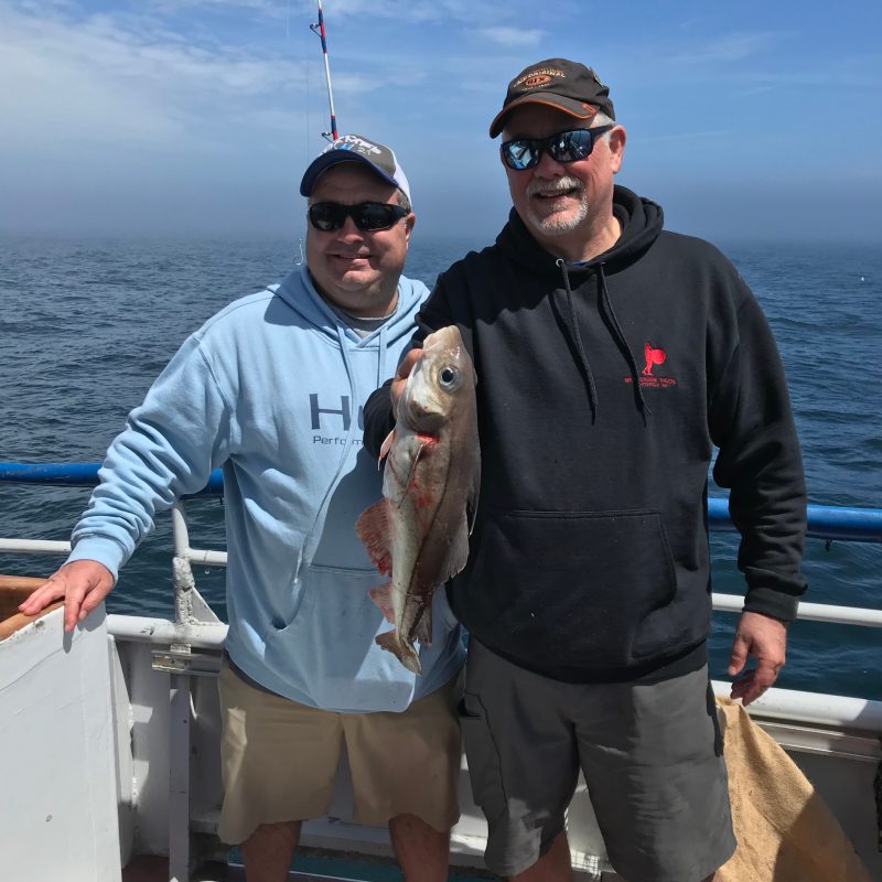 a man holding a fish in the water