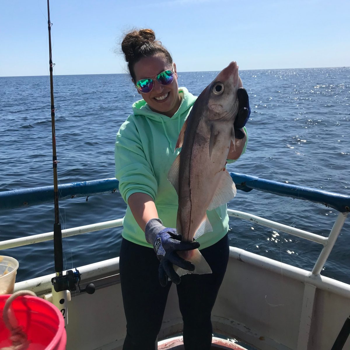 a person holding a fish on a boat in the water