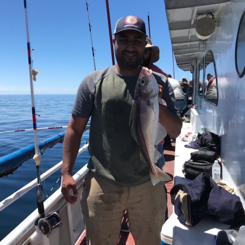a man standing next to a boat