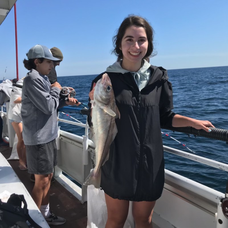 a group of people standing next to a body of water