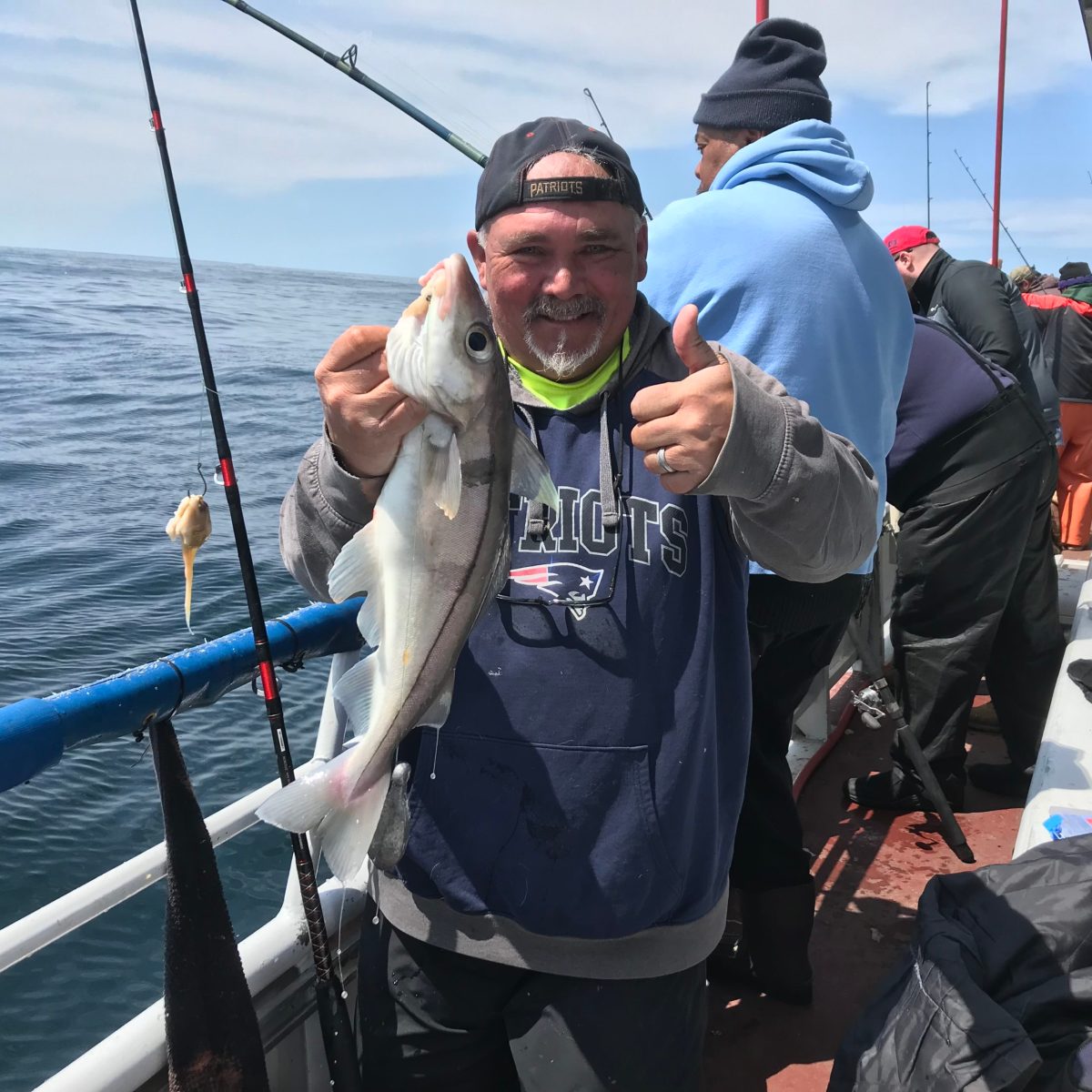 a person holding a fish on a boat