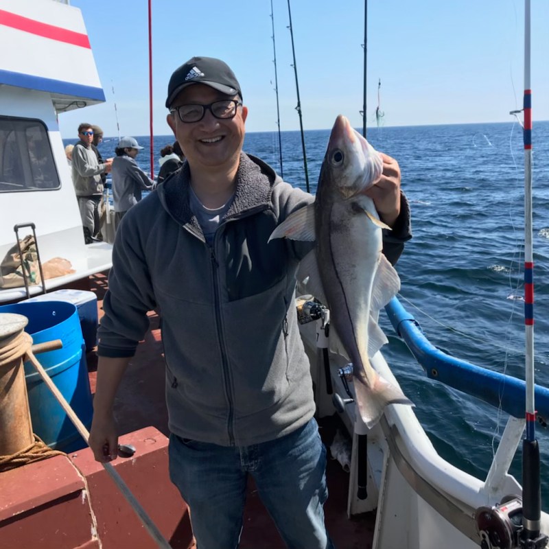 a person holding a fish on a boat