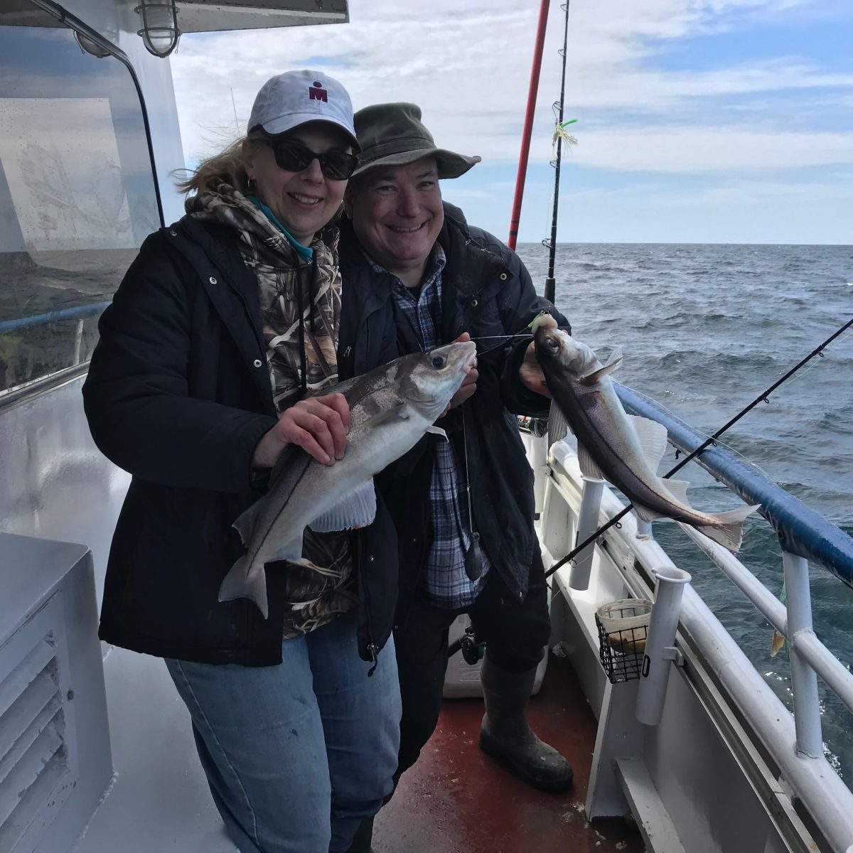 a person holding a fish on a boat