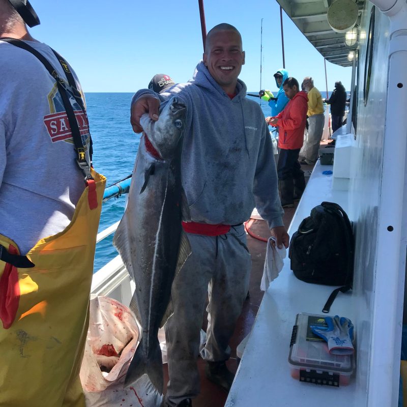 Thomas Schrammel et al. standing next to a person holding a fish