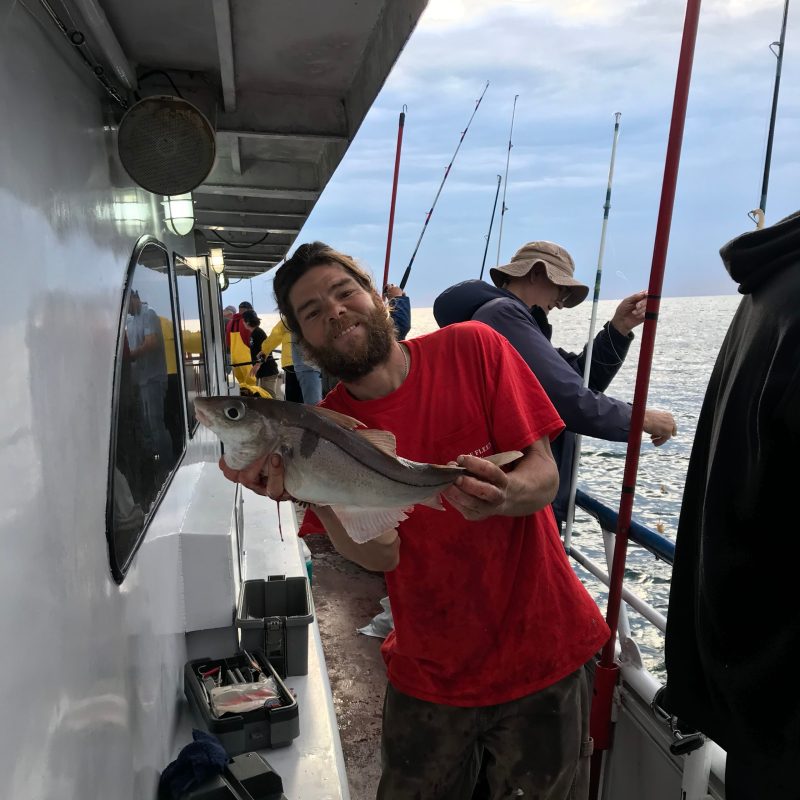 a man standing in front of a boat