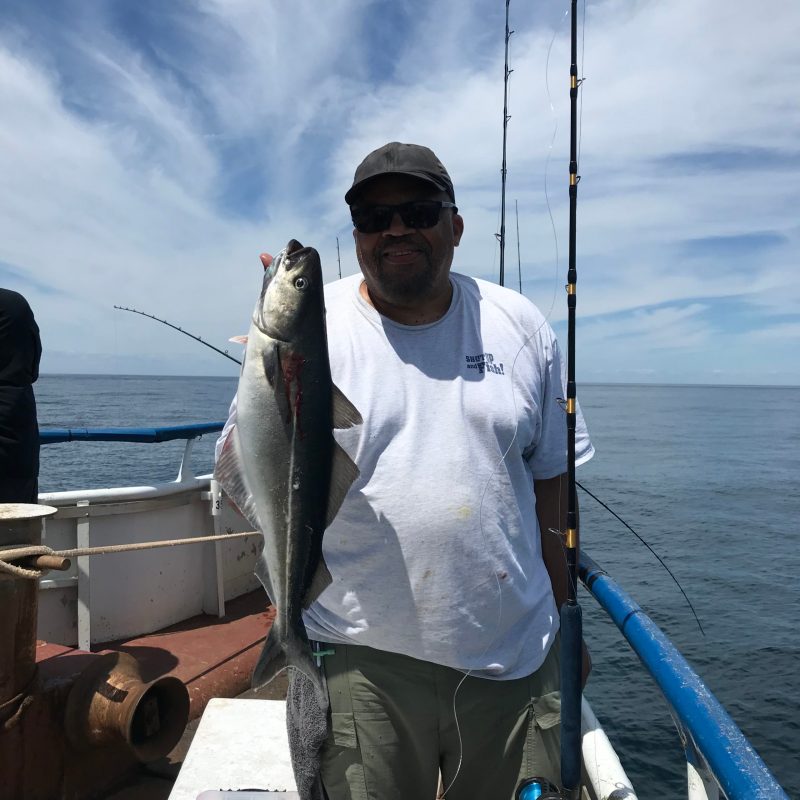 a man holding a fish in the water