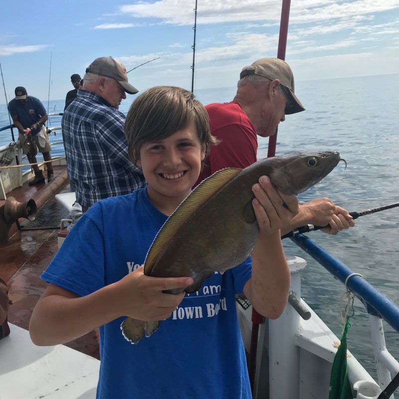 a person holding a fish in the water