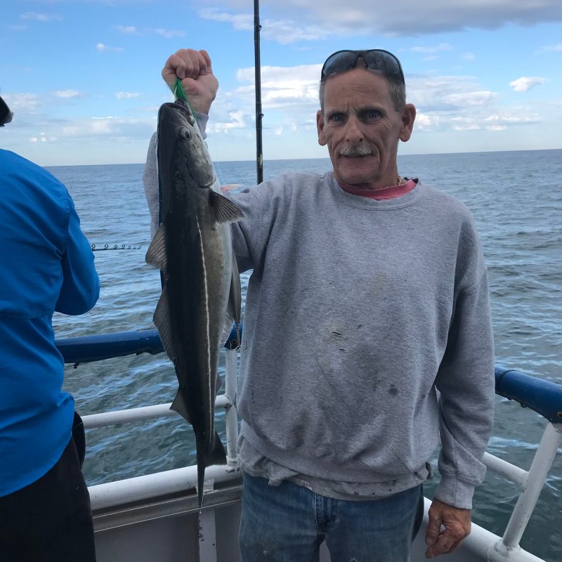 a man holding a fish in the water
