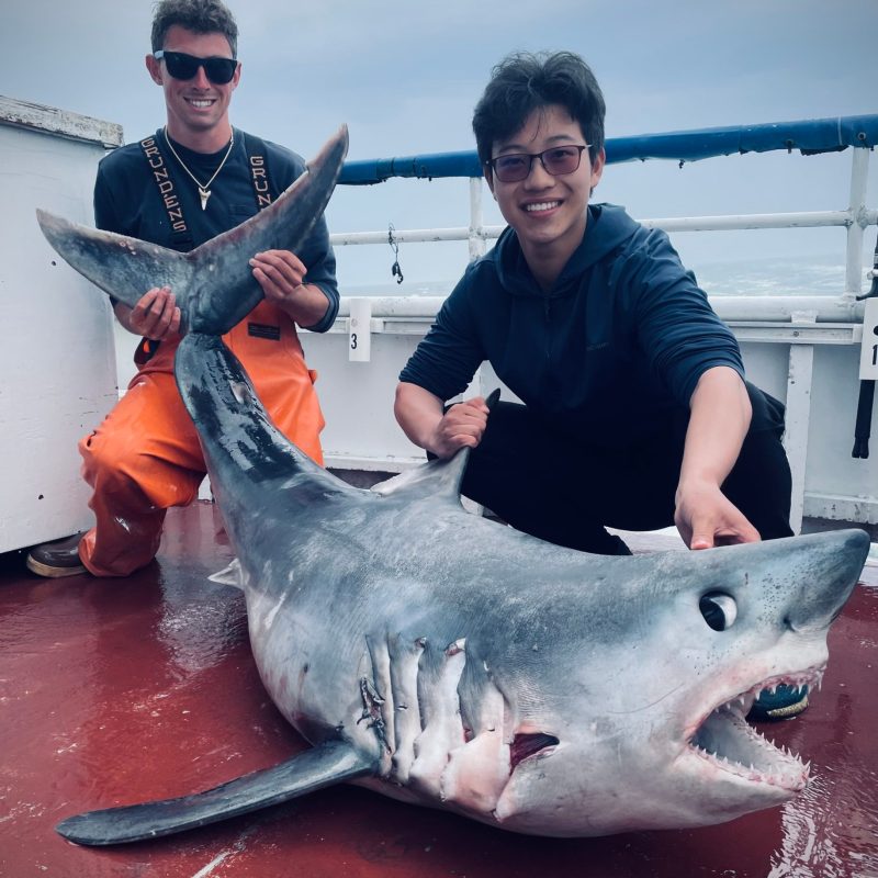 a statue of a person holding a fish