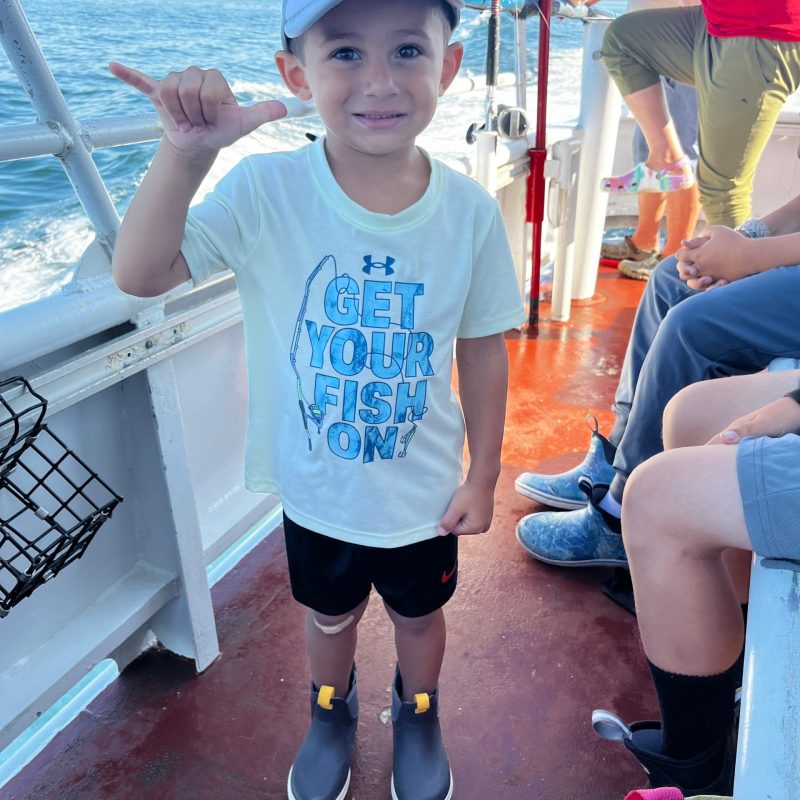 a little boy that is standing in the water