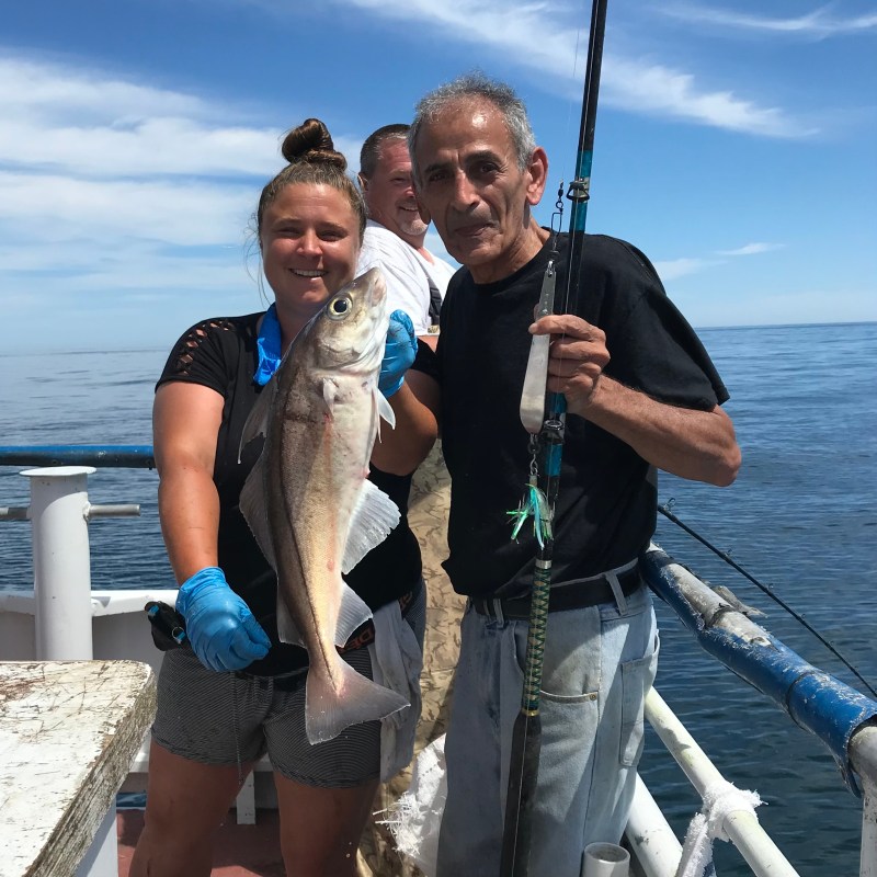 Kateb Yacine holding a fish in the water