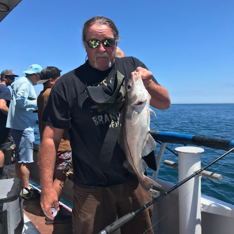 a man holding a fish in the water