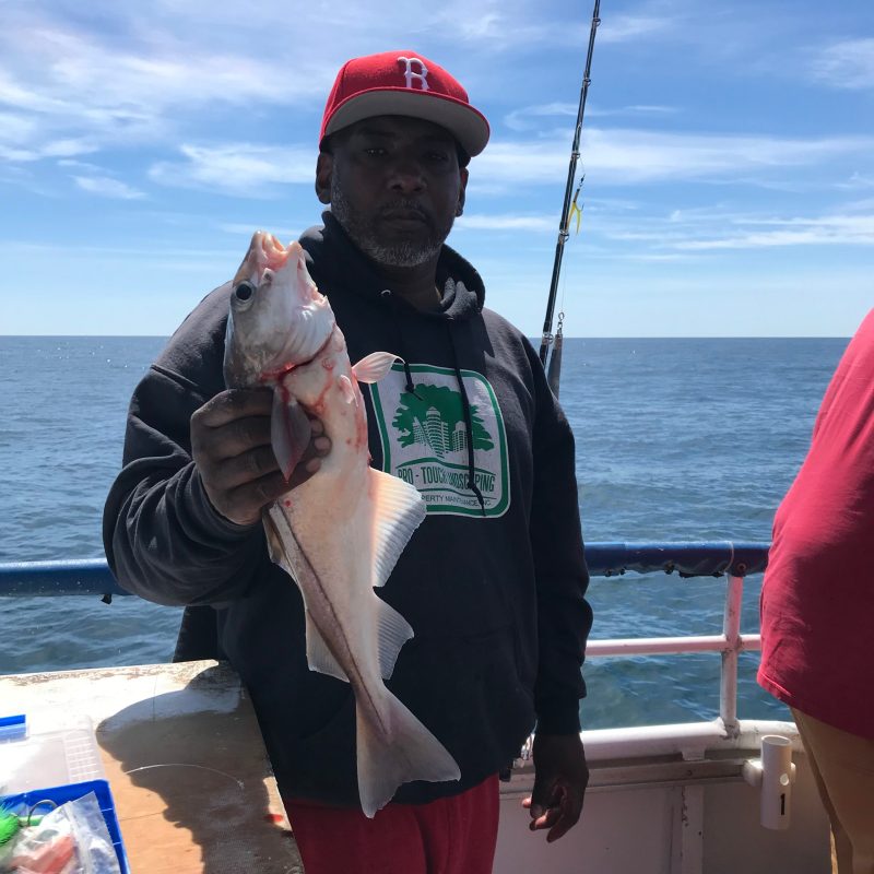 a person holding a fish in the water