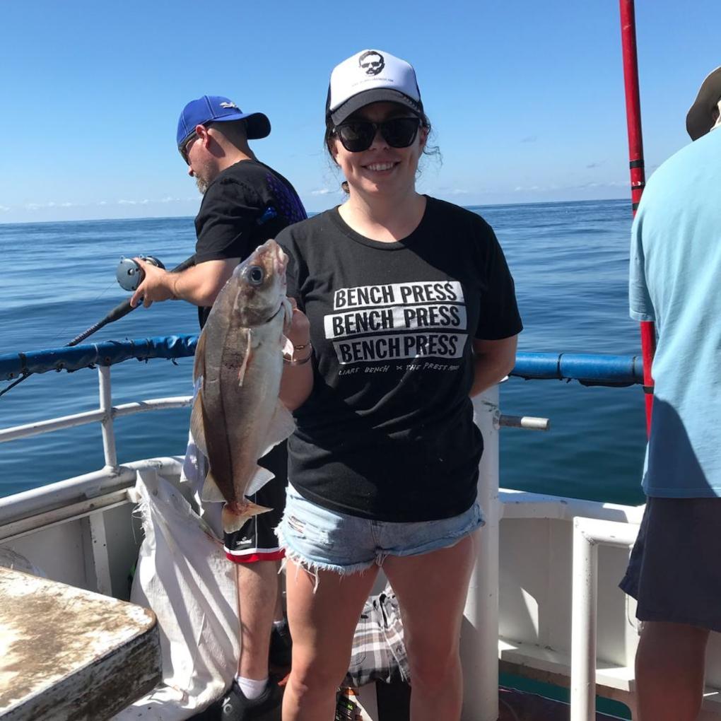 a couple of people standing next to a body of water