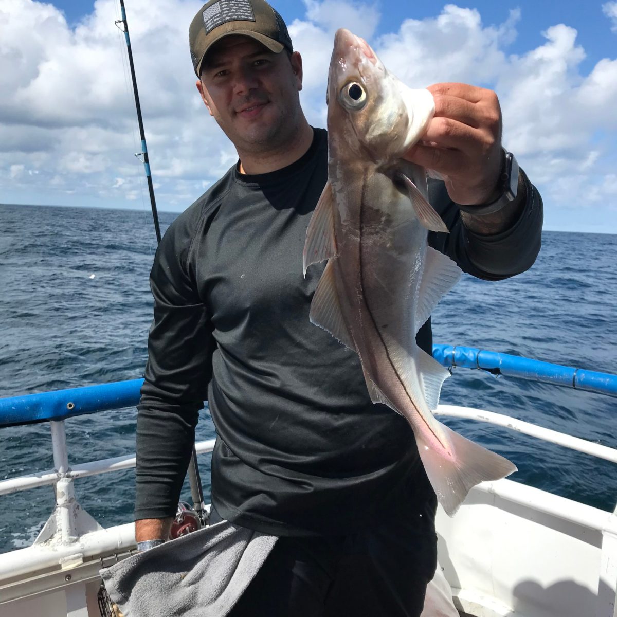 a person holding a fish in the water