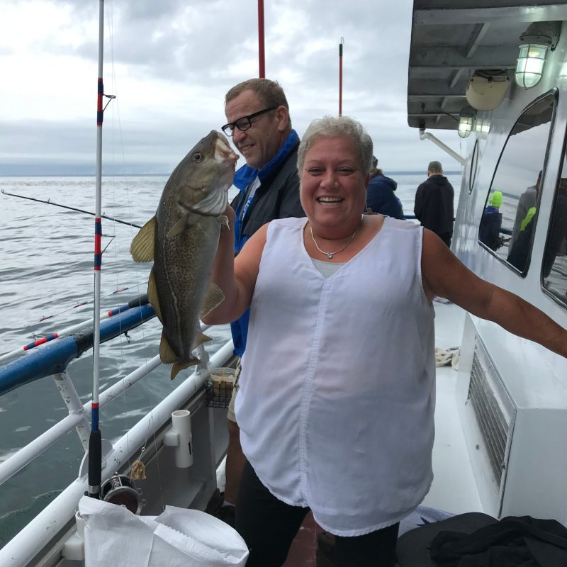 a person holding a fish