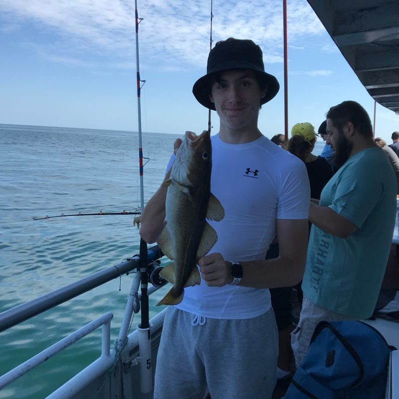 a person standing next to a body of water