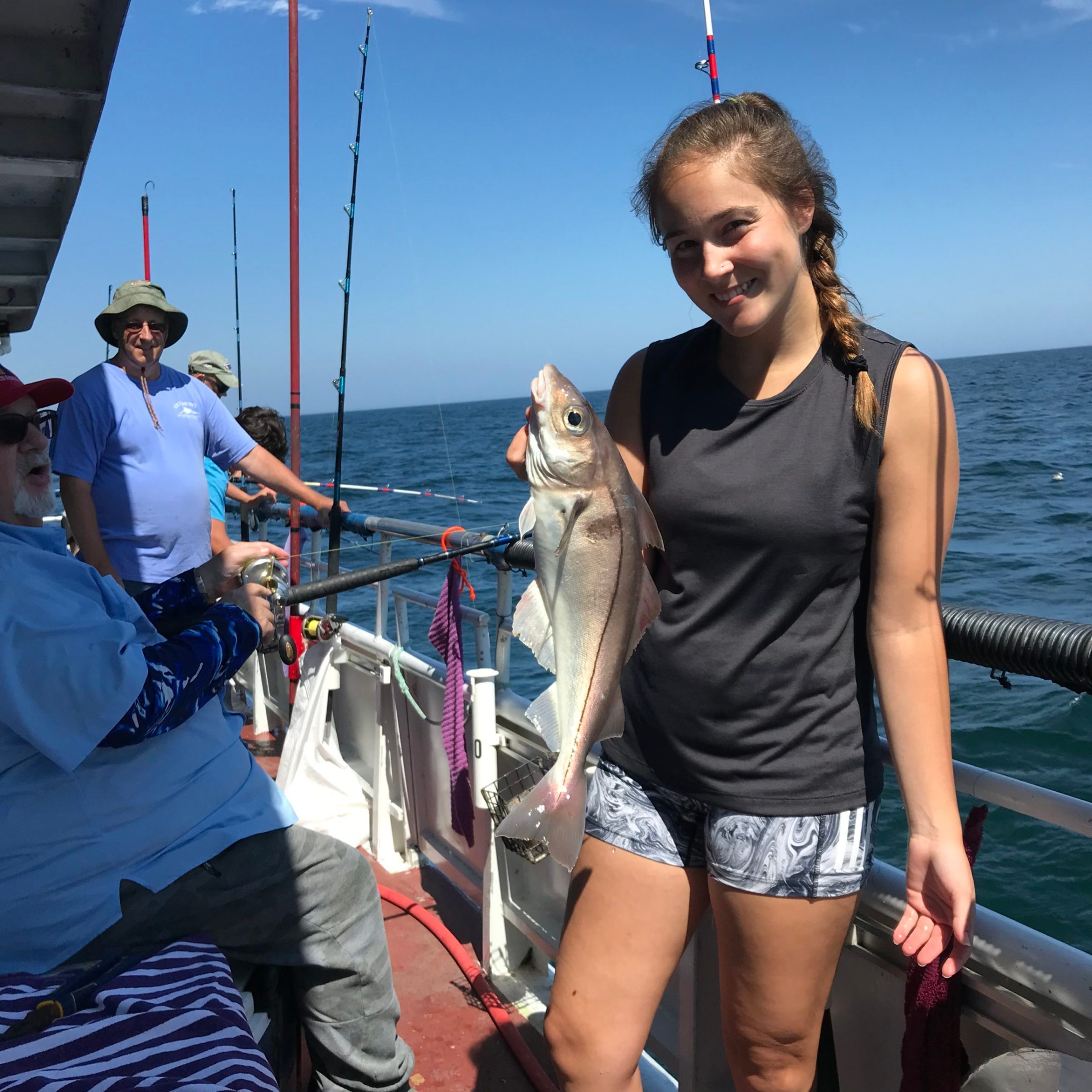 a couple of people standing next to a body of water