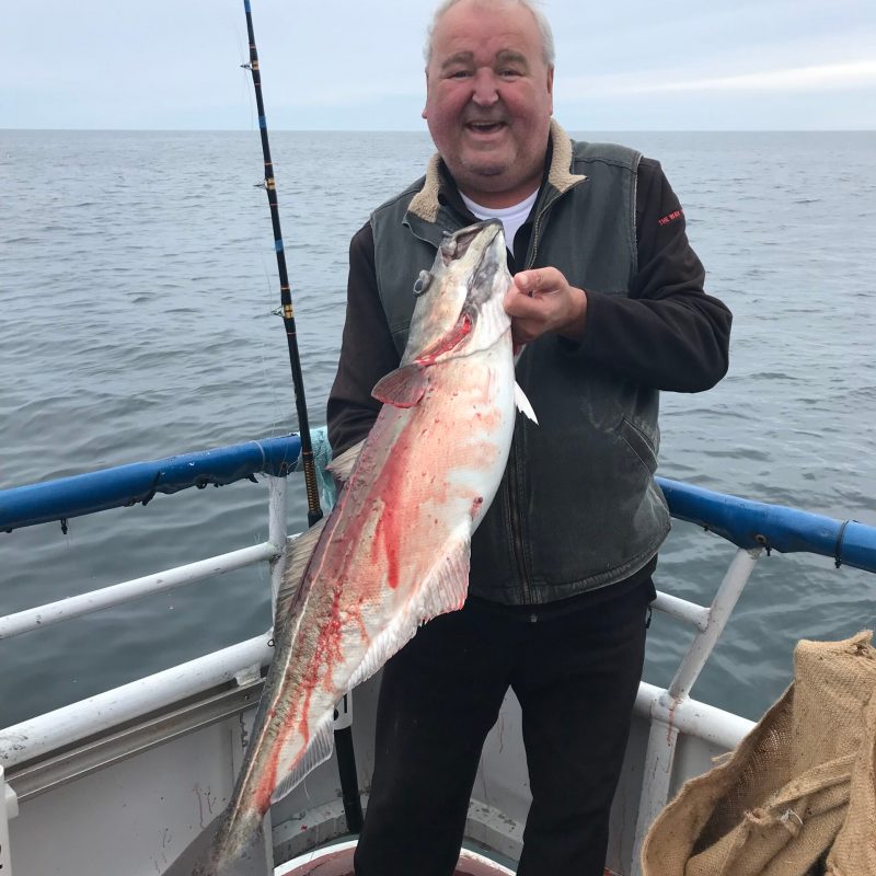 a person holding a fish in the water