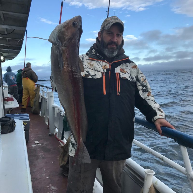 a man holding a fish in the water