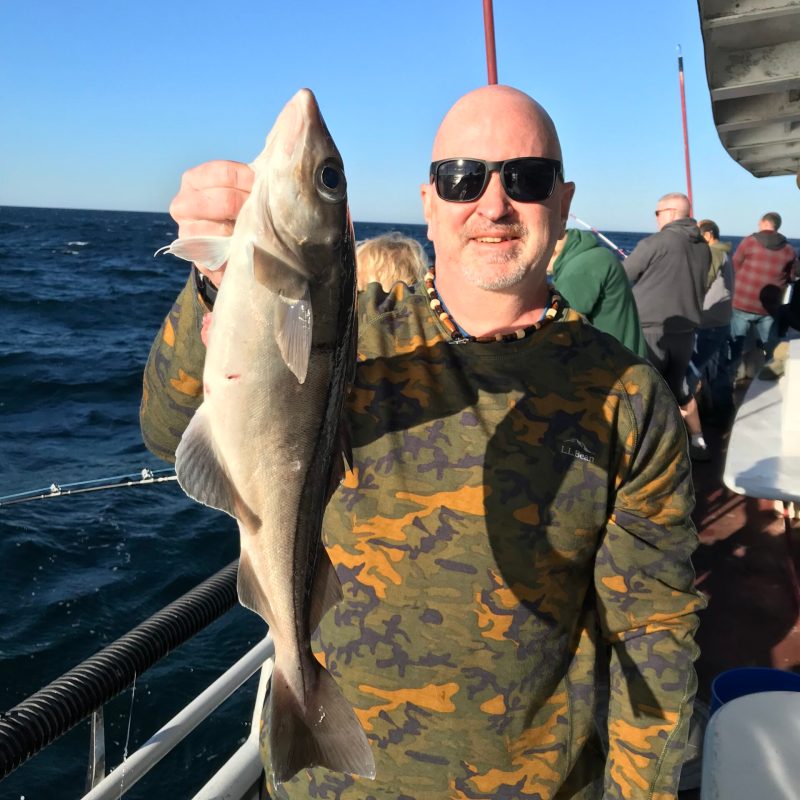 a man holding a fish in the water