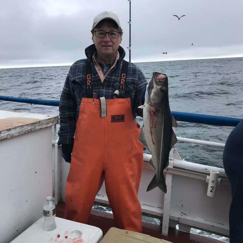 a man holding a fish in the water