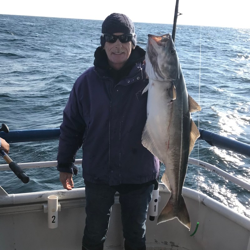 a man holding a fish in the water