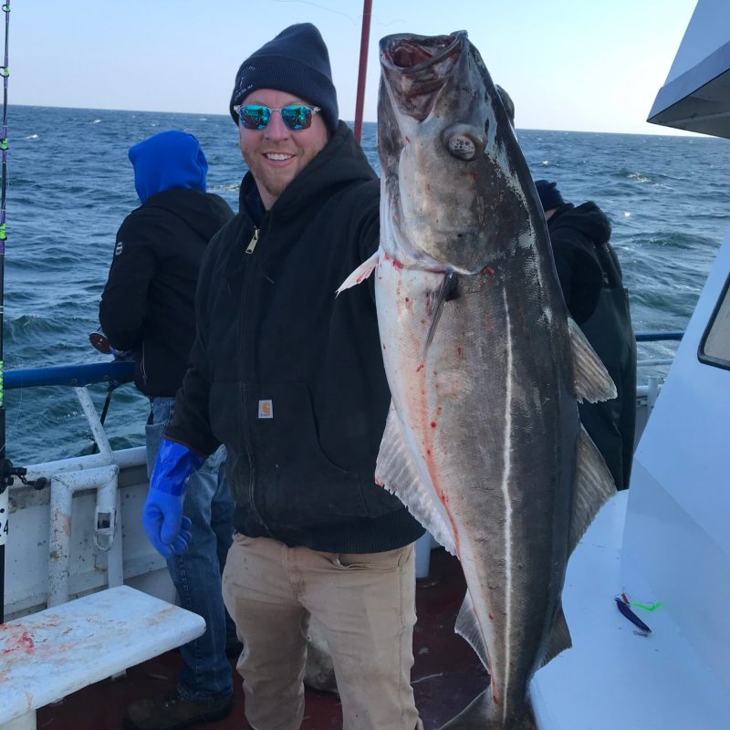 a person holding a fish in the water