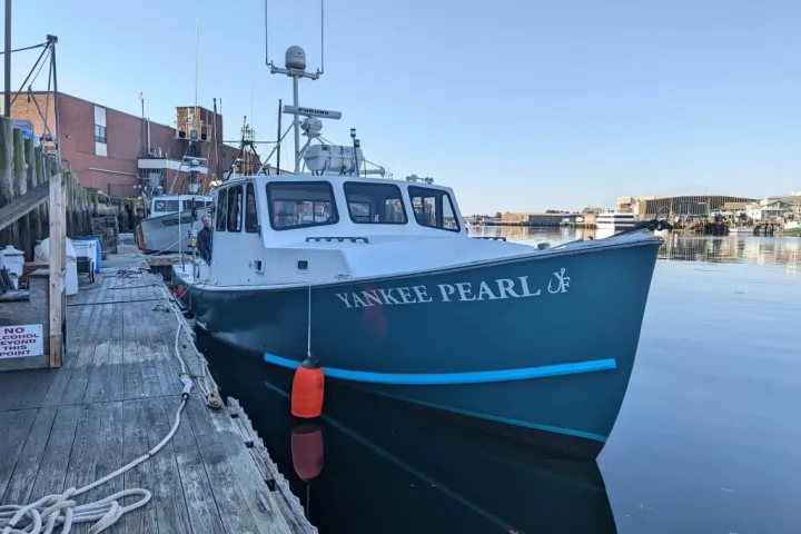 a boat is docked next to a body of water