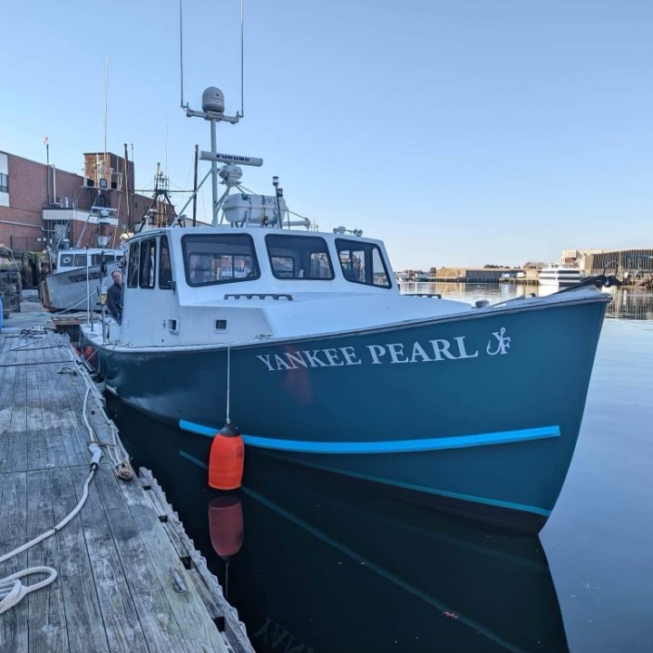 a boat is docked next to a body of water