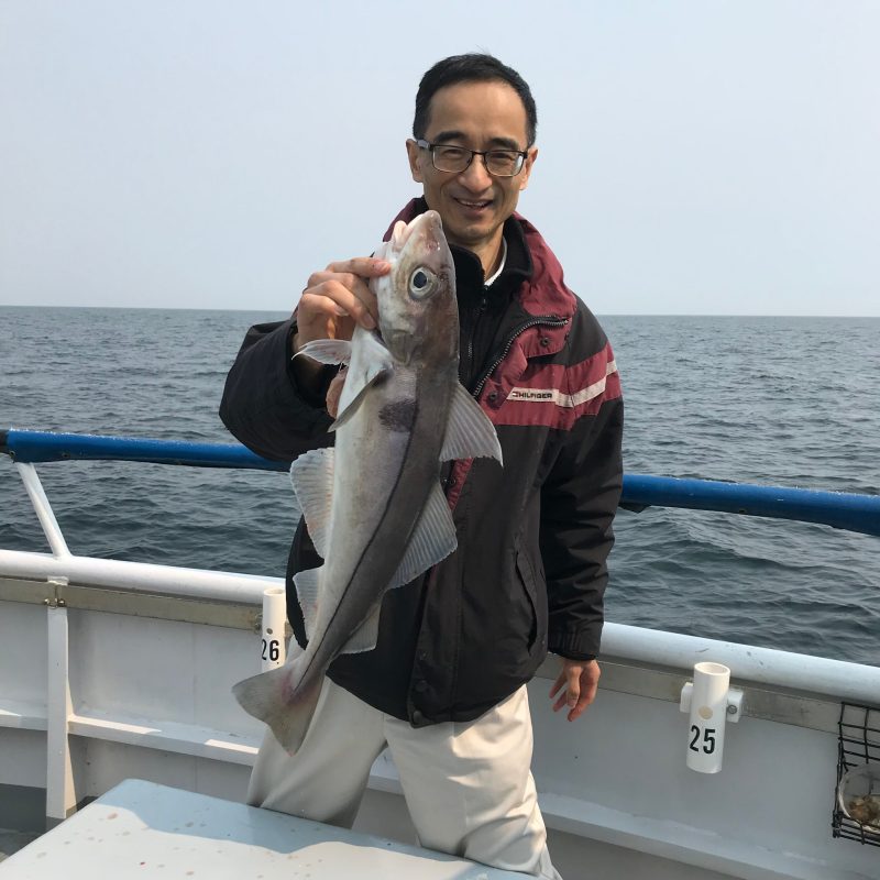 a person holding a fish in the water