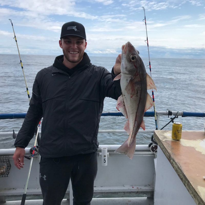 a person holding a fish in the water