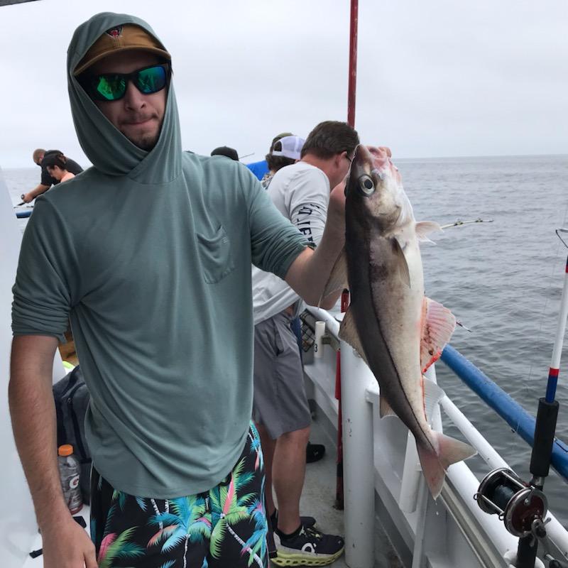 a man holding a fish in the water