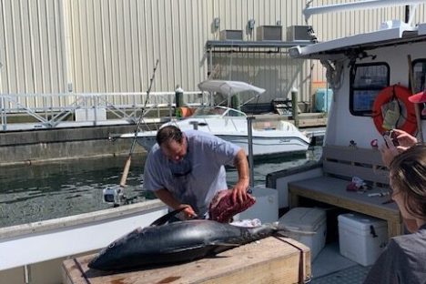 a group of people sitting in front of a building