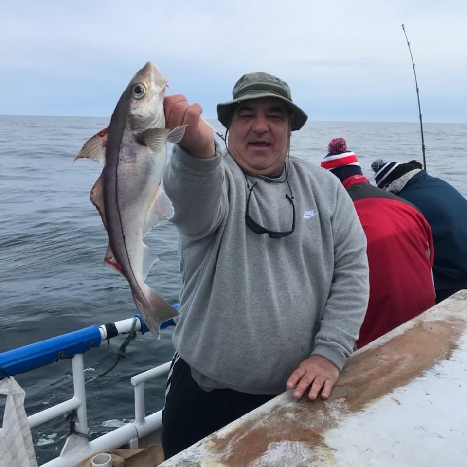 a person holding a fish in the water