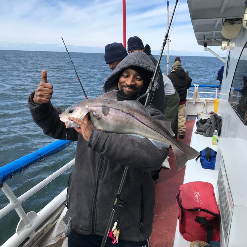 a person standing next to a body of water